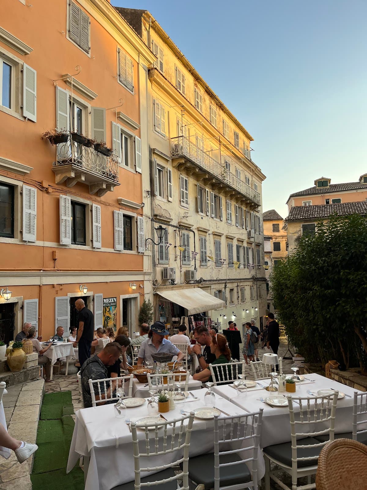 Terrace at sunset with guests and MeZen sign