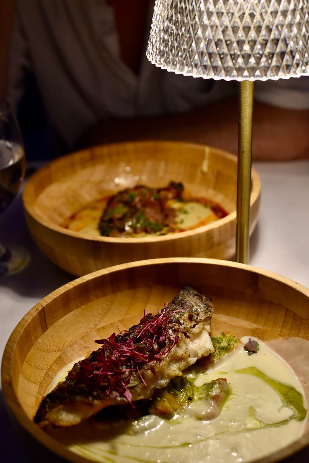 Two dishes under crystal lamp in the evening