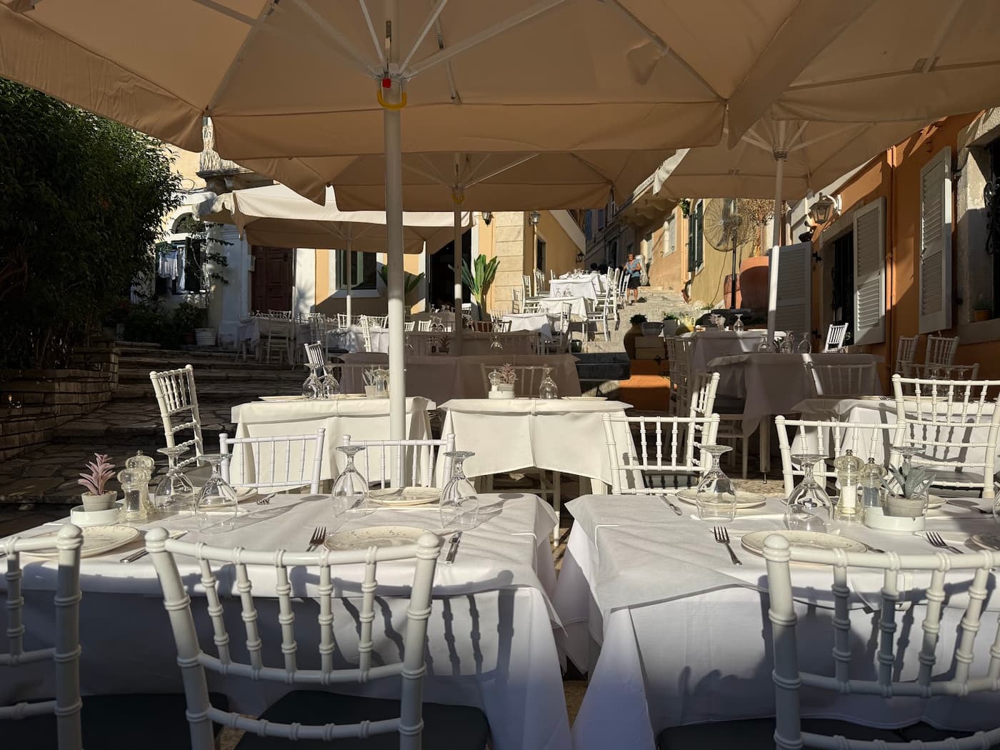 Wide terrace view with umbrellas and table settings