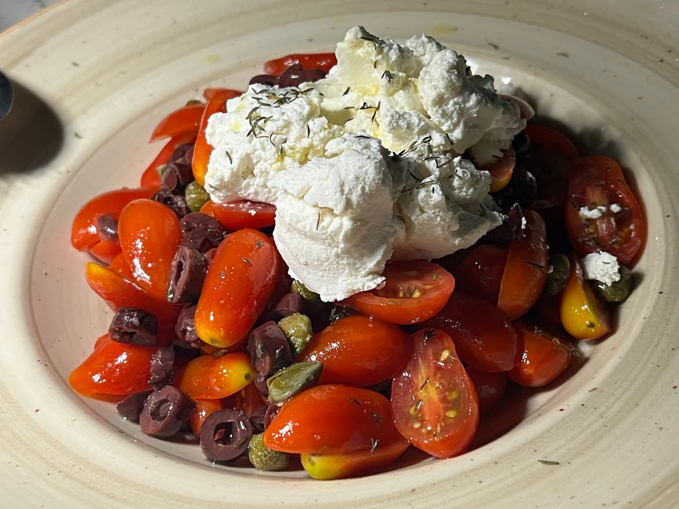 Ntakos — cherry tomato salad with feta, olives and capers