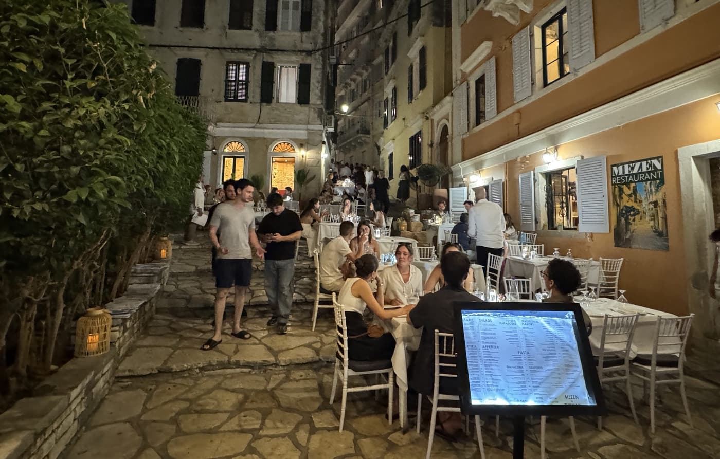 Diners on the candlelit cobbled lane outside MeZen Restaurant in Corfu
